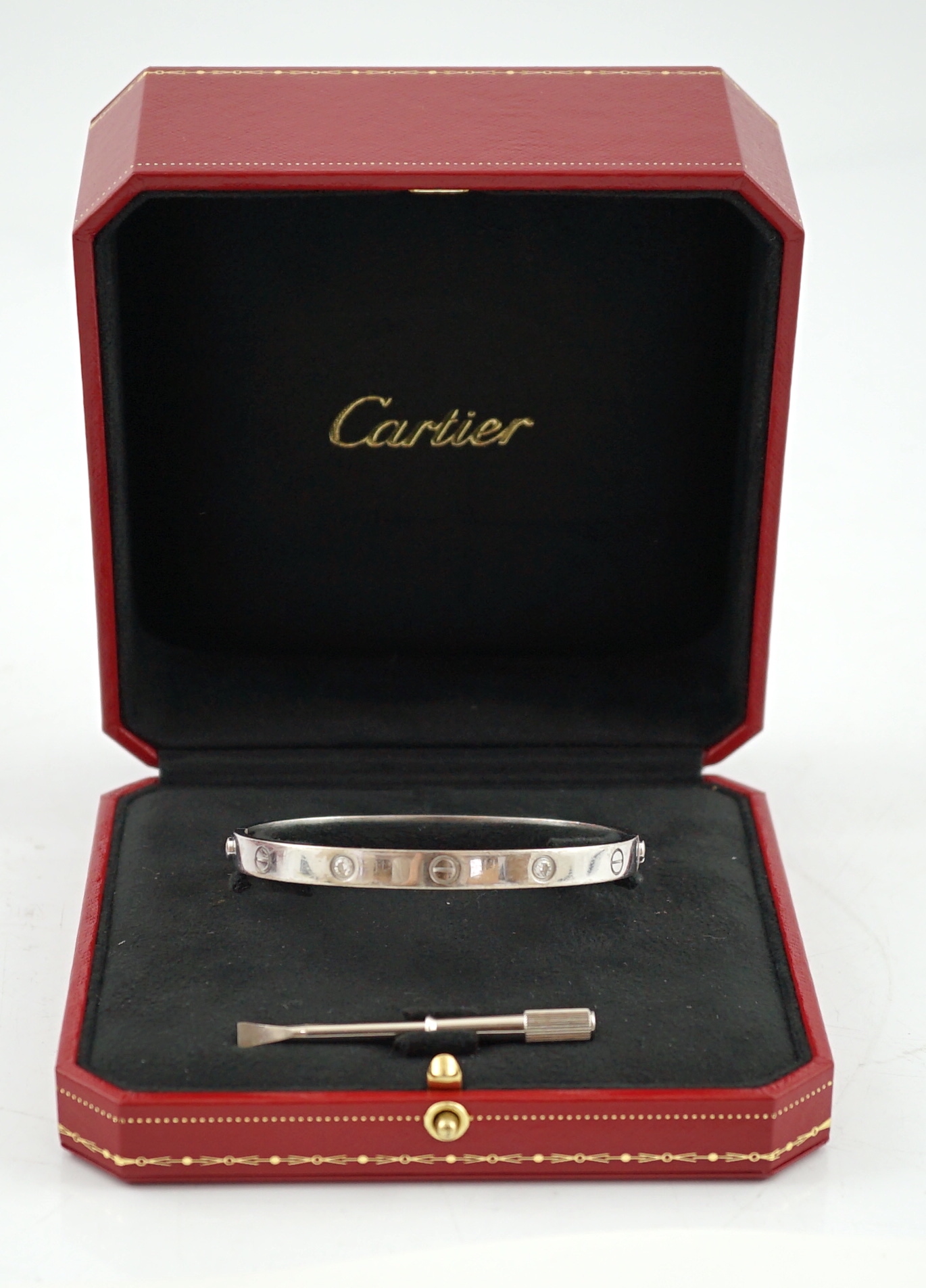 A modern Cartier 750 white gold and four stone gypsy set diamond 'Love' bangle